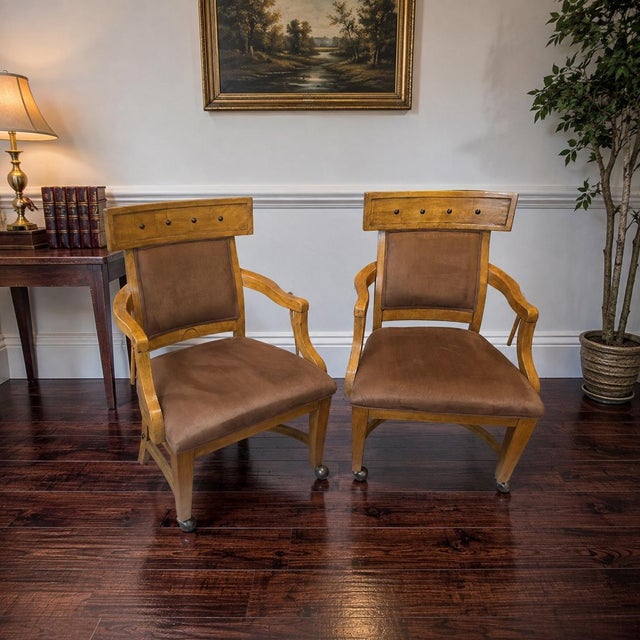 A distinctive pair of vintage armchairs featuring sculptural wood frames, upholstered accent seating, and classic wood...