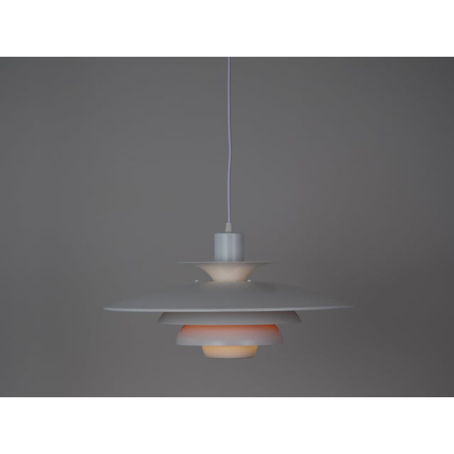 This lamp was designed by Danish designer Kurt Wiborg and manufactured by Jeka. The lamp's form is based on the principle...