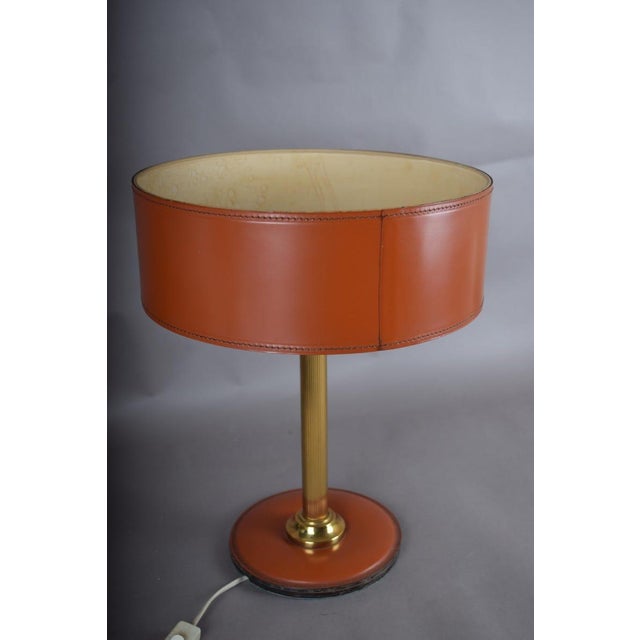 Wrapping a lamp in leather rather than fabric or metal changes how it wears over time — leather develops a patina the way...