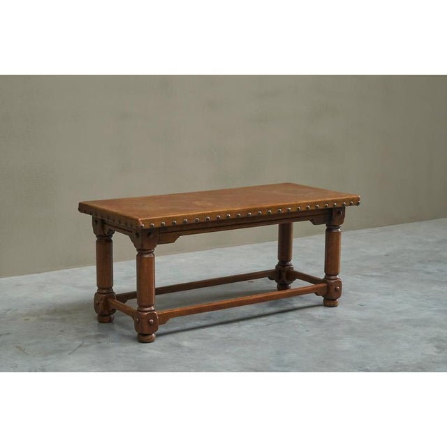 This is a wonderful, rare, early and untouched 1940s or 1950s coffee table with a cognac leather top in solid oak and...