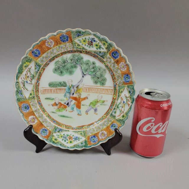 A charming Chinese famille-verte revival plate dating to the Early Republic period, decorated with a lively scene of boys...