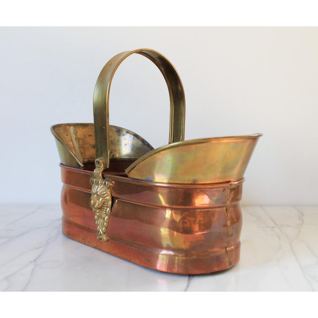 Vintage copper and brass basket with lion head motif and movable handle. No makers mark. Some age wear. Patina. Small dents.