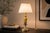 Decorative table lamp dating to circa the 1960s, combining a fluted gold-toned brass body with a contrasting silver-toned...