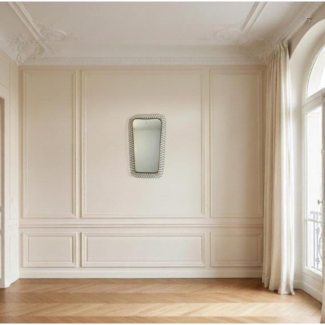 This mirror is an elegant example of mid-century Italian design dating back to the 1950s. It is a wall-mounted (or...