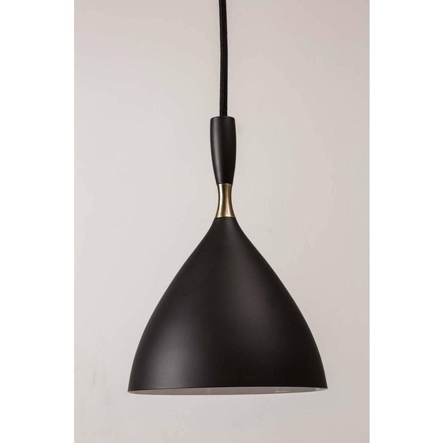 Birger Dahl Pendants in the Manner of Stilnovo. Architectural pendant lights designed, circa 1954 and executed in enameled...