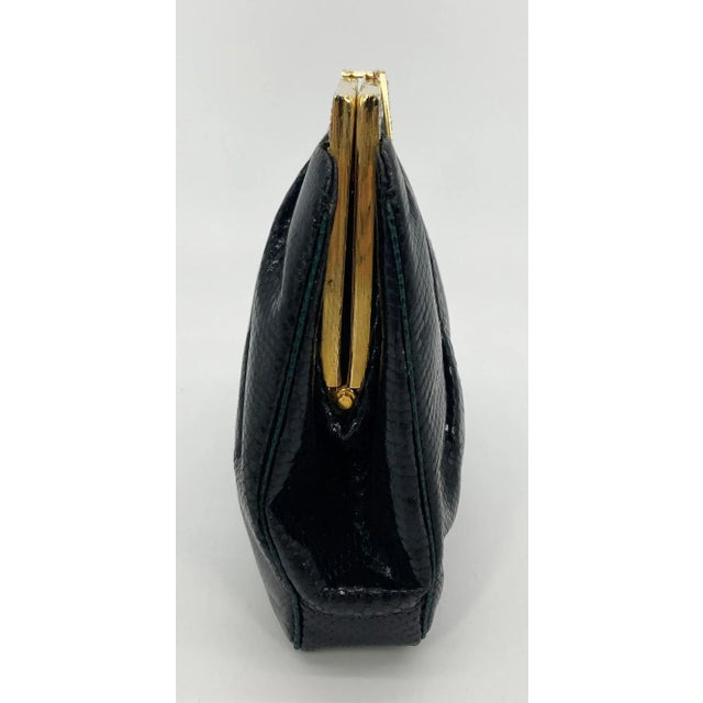 Vintage Judith Leiber Black Lizard Black Enamel Gold Top in excellent condition. Black lizard exterior trimmed with gold...