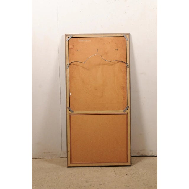 A French trumeau style mirror, with oil painting at top, from the mid 20th century. This vintage pier mirror from France...