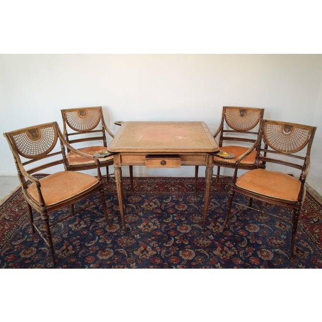 Set of four begere chairs with matching leather top games table. Four retractable chip holder or ashtray on each corner....