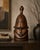 A striking hand-carved West African helmet mask in the Senufo tradition, this sculptural hardwood piece immediately...