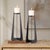 This Striking Pair Of Candle Holders Features A Modern Base Crafted From Iron In A Matte Black Finish With Subtle Antique...