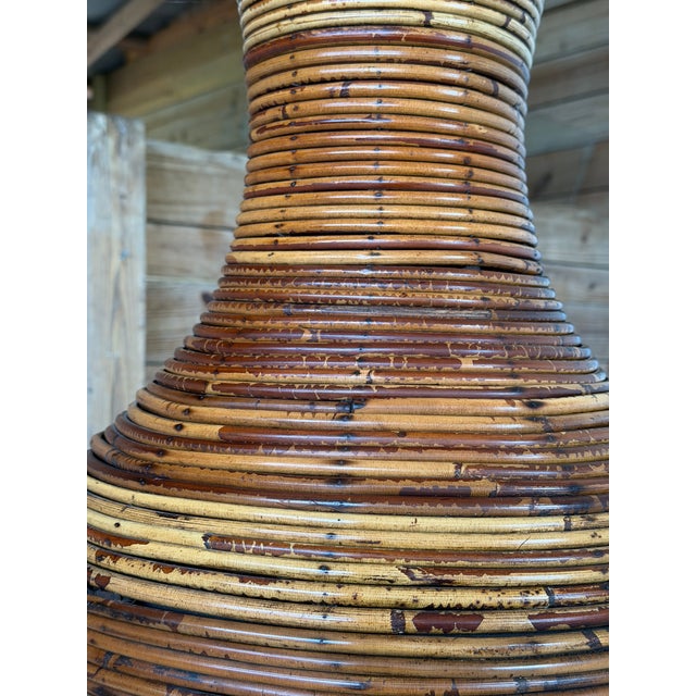 A truly monumental vintage sculptural floor vase crafted from tightly wrapped rattan over a wood form. The striking...