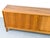 Stunning walnut sideboard with two sliding doors featuring oval recessed handles. Inside, two compartments each have an...