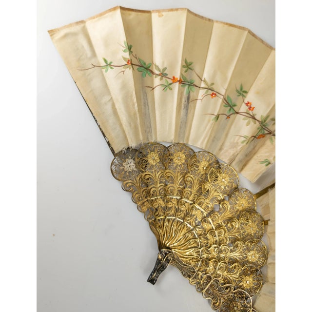 We are selling this gorgeous sterling silver filigree fan with floral decoration. The silk fan has simple floral designs...