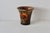 A large vintage decorative cachepot/wastebasket featuring a dark background adorned with vibrant decoupage floral motifs....