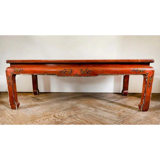 Nice rectangular Chinese red lacquer coffee table. The legs are straight. The top is decorated with branches, flowers and...