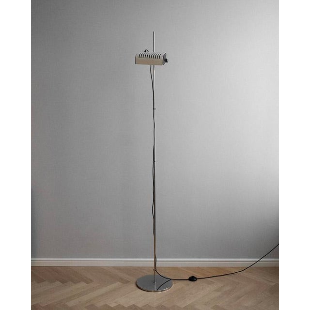 This tall mid-century lamp combines functionality with timeless industrial design. The height-adjustable and rotatable...