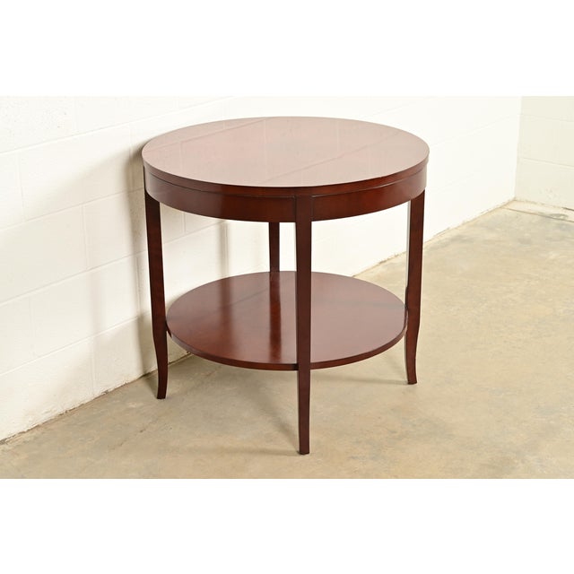 An elegant modern Regency style two-tier center table or tea table By Kindel Furniture USA, Circa Late 20th Century...