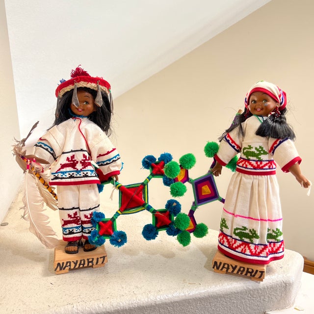 These are two dolls, a boy and a girl, from Mexico that are dressed in traditional Huichol costumes. The heads and bodies...