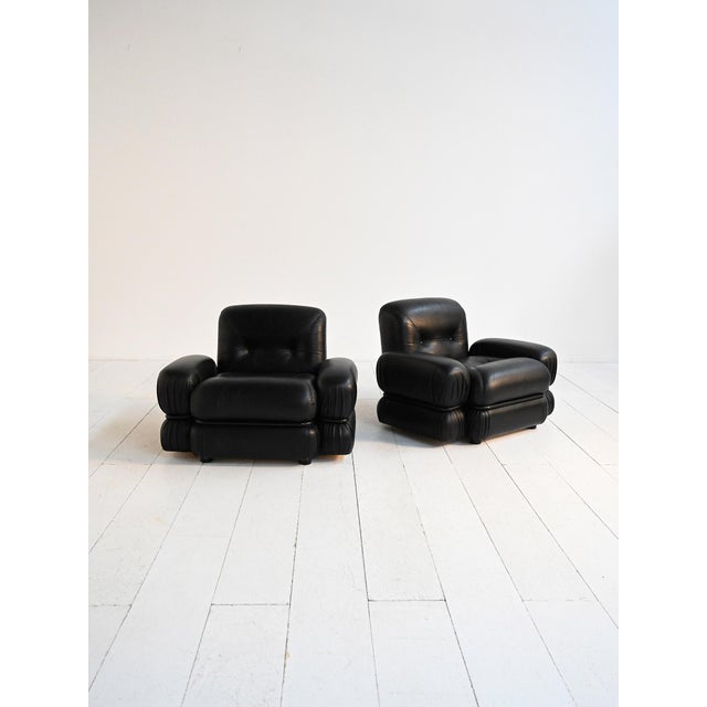 Pair of armchairs with tubular steel frame and original black leather upholstery. Made in Italy, 1970s. Pair of Italian...