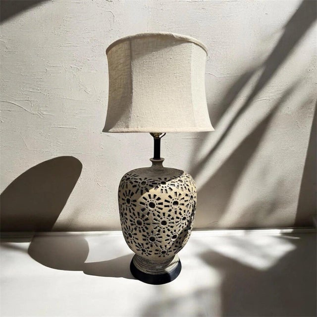 A striking 1969 Mid-Century Modern ceramic table lamp by Quartite Creative Corp., featuring a sculptural ovoid form with a...