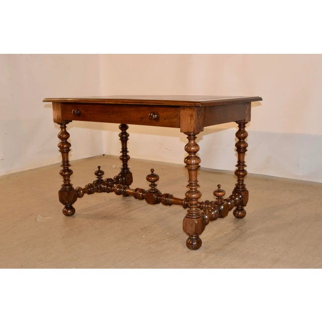 18th century walnut writing table with a banded and beveled edge around the top, following down to a simple apron...