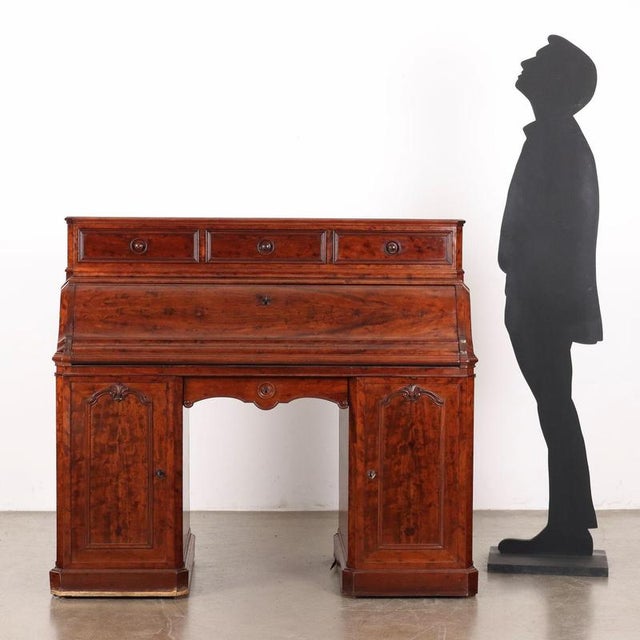 Mahogany drop-leaf desk, front with two paneled doors with drawers and open compartments inside, central drawer with...