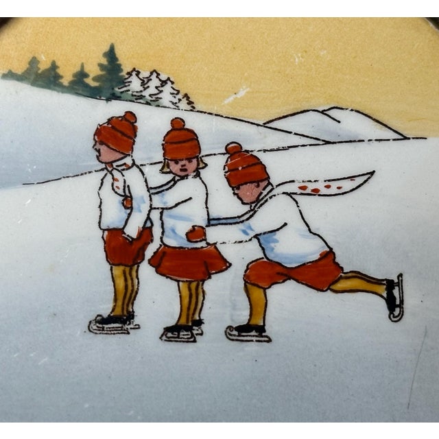 Rare & Original German Brass Framed Porcelain "Skating Children" Trivet Coaster Plate for your consideration. The dish...