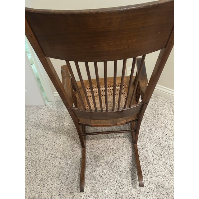1950s Vintage Arts & Crafts Carved Oak High-Back Rocking Chair With Cane Seat &Arms For Sale - Image 5 of 7