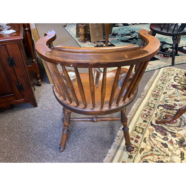 20th century reproduction of a classic antique Windsor style arm chair. Very shallow saddle seat, baluster legs, scroll...