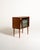 Scandinavian teak bar cabinet from the 1950s, with a sliding shutter door, brass trim, mirrored interior, and glass...