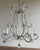 An elegant Italian crystal beaded chandelier, mid-20th century, featuring six lights on gracefully scrolled arms entirely...