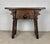Rustic solid walnut stool or side table featuring hand-carved decorative cut-out details and a sculptural design. The...