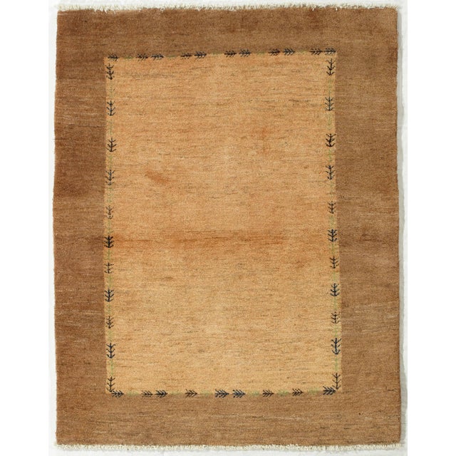 Vintage hand-knotted Persian Lori Gabbeh wool rug with a camel field in a minimal composition, framed by a subtle border...