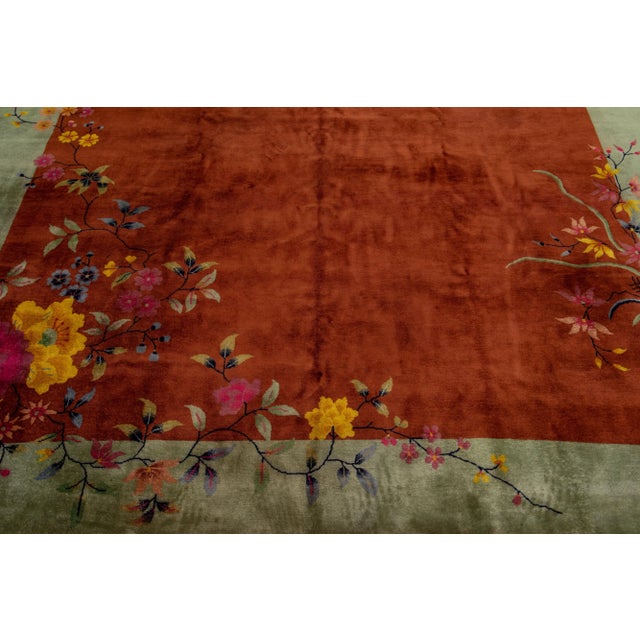 Beautiful antique Art Deco hand-knotted wool rug with a brown color field. This piece has a green frame with multicolor...