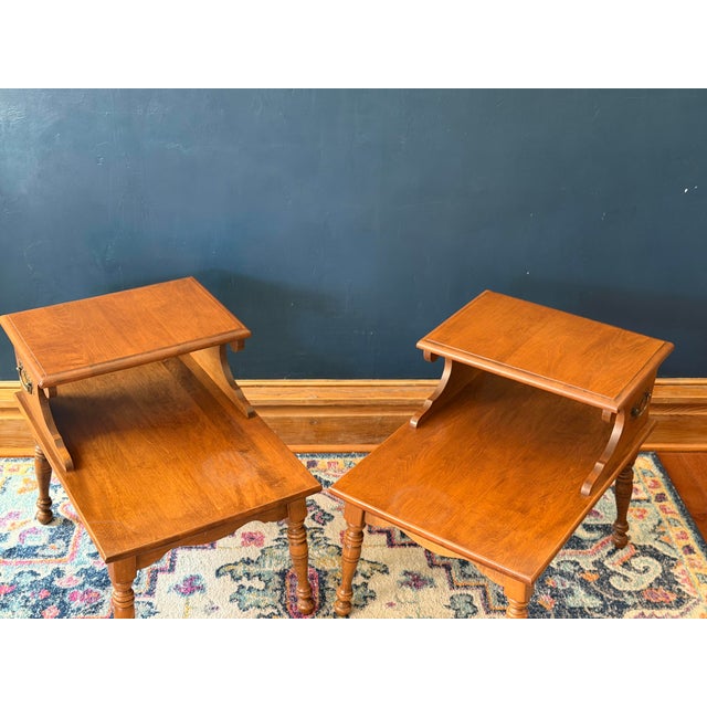 Offered is a handsome pair of "Old Colony" step end tables by the iconic American maker Heywood-Wakefield. Model C 2074 G....