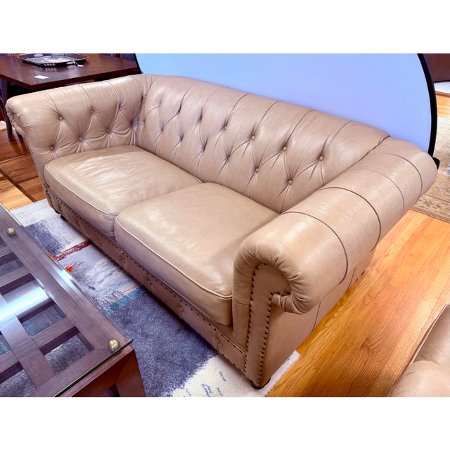 A classic Bernhardt leather loveseat with the timeless appeal of a Chesterfield silhouette. Upholstered in a warm camel-...