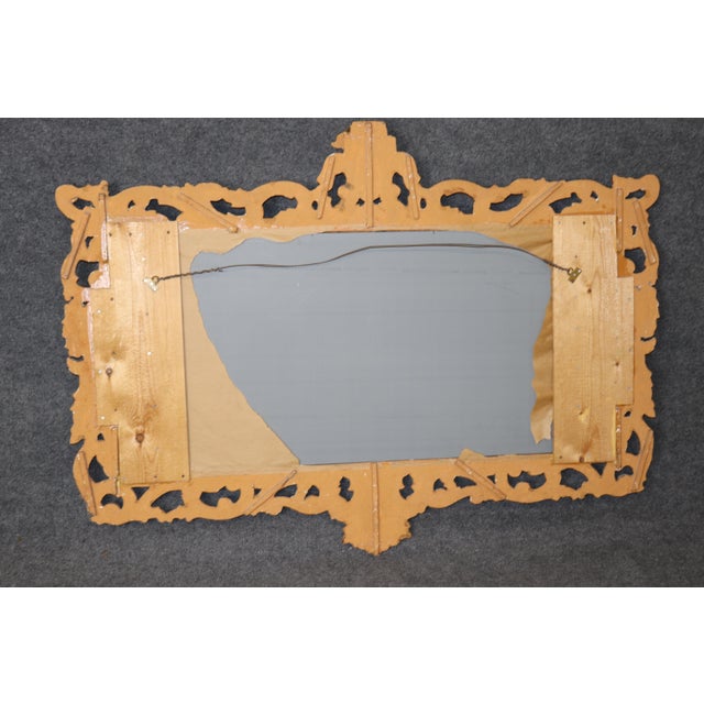 Dimensions: 46 inches high x 63.25 inches wide x 4.5 inches deep An exquisite Italian Rococo style wall mirror, dating to...