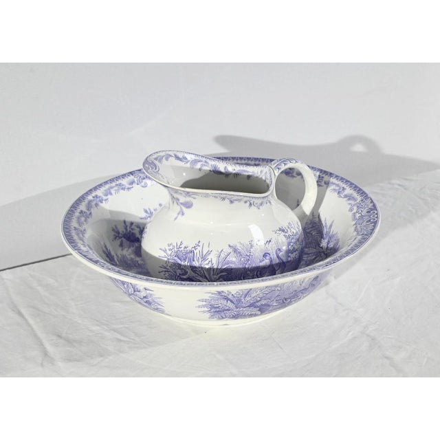 This set is composed of a basin and a jug with duck decorations. The basin has a manufacturing defect in the printing of...