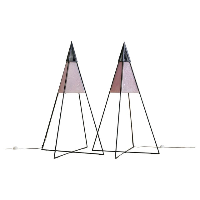 Sold and priced individually. A pyramidal floor lamp sourced in northern Italy, circa 1980s. Its geometric frame is...