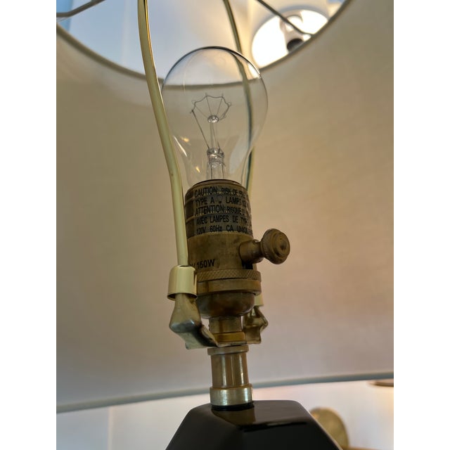 Visual Comfort. The Bayless Lamp features a modern design with a black faceted shaped body on a unlacquered brass base and...