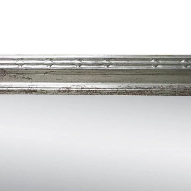 Neoclassical Regency style handcrafted mirror. Rectangular hand carved wooden structure with silver foiled finish, Spain,...