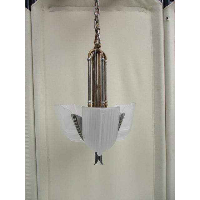 This stunning Art Deco chandelier or pendant light has three frosted slip glass shades in a beautiful streamline design....