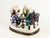 An interesting porcelain inkwell set with sander Designed as a figural group it features a very detailed scene of two...