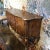 Shaped server with two doors, and three drawers with a distressed silver gilt edge detail featuring walnut oyster wood...