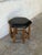 This striking hexagonal ottoman features a prominent nailhead trim bordering its upholstered top. Elaborately turned...