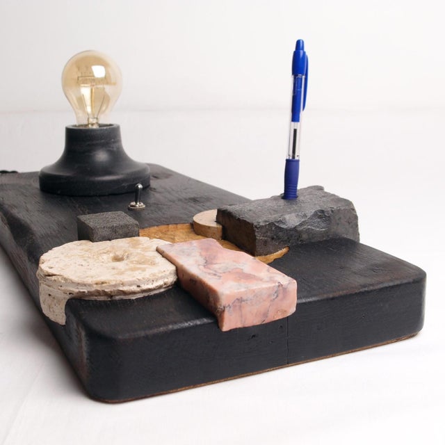 The Puzzle Lamp is a hand-carved wood, stone, and marble table lamp from the Raw Collection by Gabor Gobi, made from a...