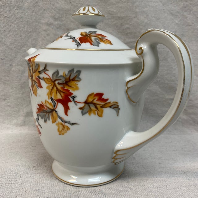 Golden Autumn Tea Pot featuring colored Autumn leaves and gold trim on a white porcelain body. Made in Japan. This tea pot...