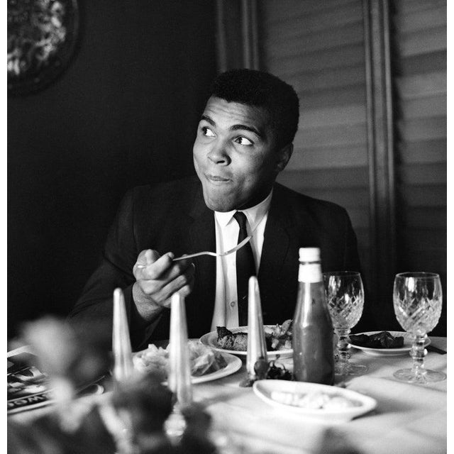 Muhammad Ali 16th August 1965: World heavyweight boxing champion Muhammad Ali enjoys supper in a restaurant. (Photo by...