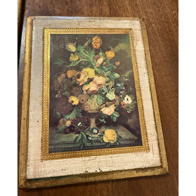 This is a set of two vintage Italian Florentine wall plaques featuring a charming floral print centrally surrounded by an...