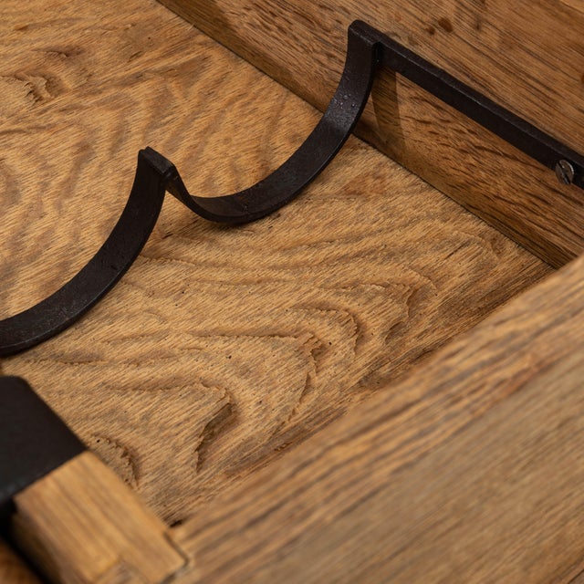 This 20th Century French oak bar table offers a charming blend of rustic craftsmanship and clever functionality....